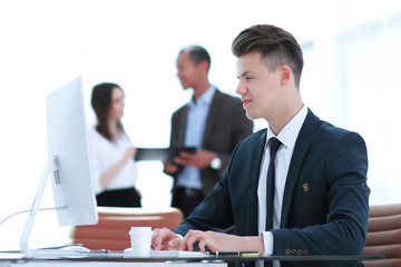 Fototapeta premium employee sitting behind a Desk in the office .