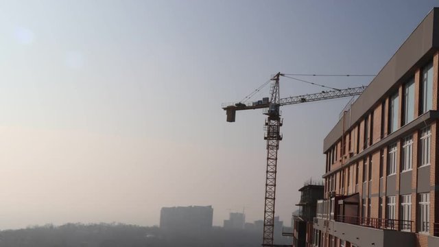 timelapse video crane work at a construction site near a multi-storey building