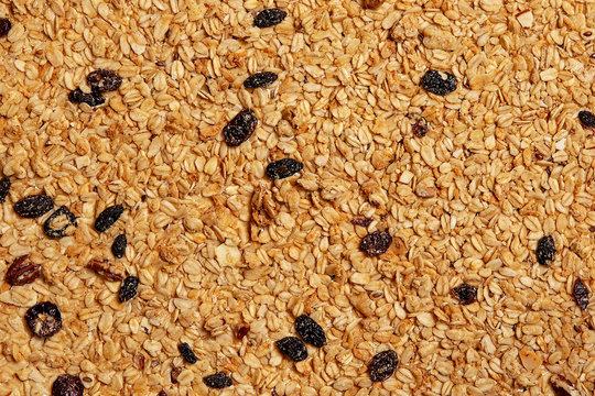 background of granola with nuts and raisins. texture of oat granola. flat lay, top view