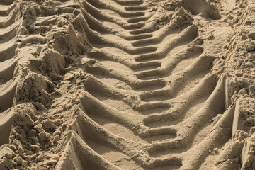 Tires marks on sand background