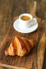 Bread and coffee espresso isolated on wooden table