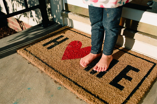 little kid feet on welcome mat