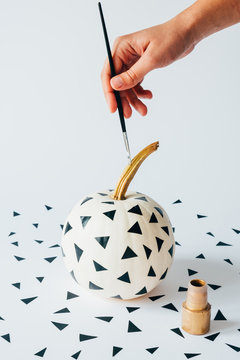 Painting a white pumpkin with geometric decoration