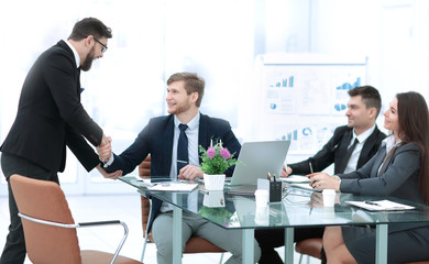 handshake Manager and employee in the workplace