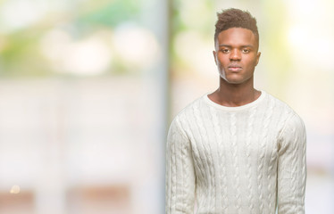 Young african american man over isolated background with serious expression on face. Simple and natural looking at the camera.