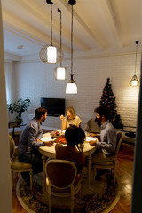 Friends celebrating Christmas or New Year eve at home