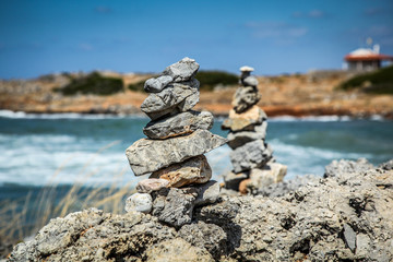 Pyramid of stones  on the sea and sky background