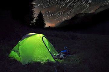 Star trail in San Pellegrino and long exposure tent (Dolomites, Italy)