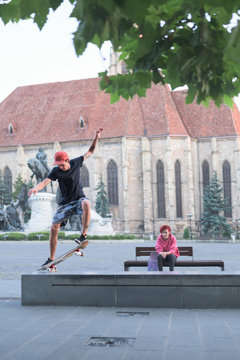 Caucasian teenage boy performing kickflip tricks with skateboard
