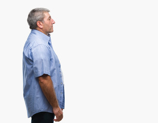 Fototapeta premium Handsome senior man over isolated background looking to side, relax profile pose with natural face with confident smile.