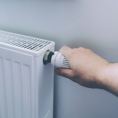 Man hand on battery temperature controller heating close up