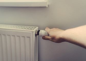 Men hand at battery temperature controller heating close up