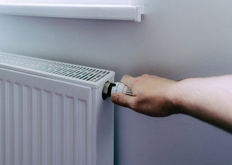 Man hand on battery temperature controller heating closeup