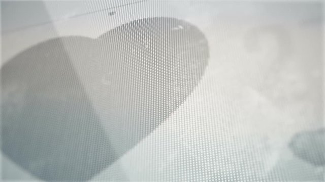 Abstract background with animation of social like button as heart shape with counter of on touch screen mobile gadget. Macro view of fingerprints on glass screen.