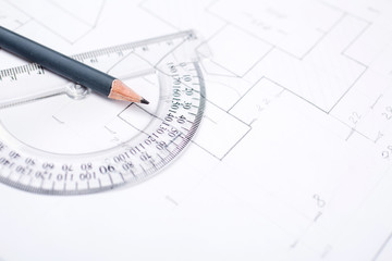 Pencil on a transparent protractor on the table in the draftsman