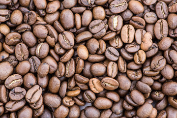 Coffee grains in the bottom of the image on a gently light background