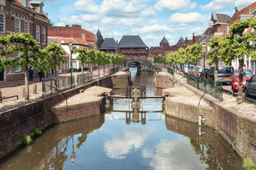 The canal Eem with in the background the medieval gate The Koppelpoort in the Dutch city of...