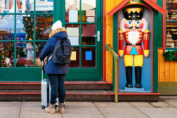 Girl with backpack and luggage bag at Nutcracker house Berlin