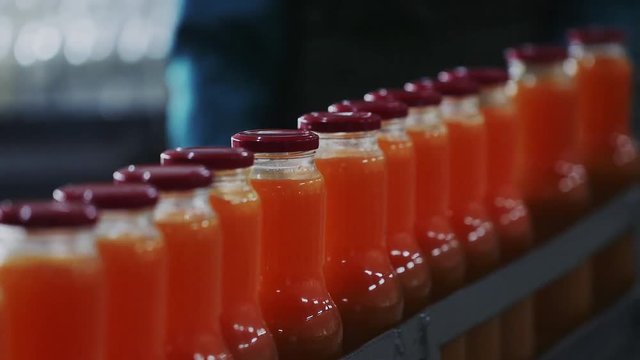 Glass bottles of natural juice in production