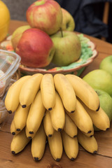 A bunch of yellow bananas, red and green apples