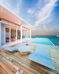 Beautiful view of Swimming Pool with  the sea at sunlight  - 3d rendering