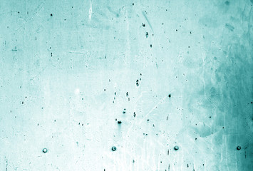 Part grungy metal door with rust in cyan color.