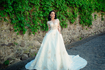 Fototapeta premium Wonderful bridal gown. Beautiful wedding dresses in boutique. Elegant wedding salon is waiting for bride. woman is preparing for wedding. Happy bride before wedding. Extremely happy