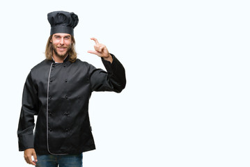 Young handsome cook man with long hair over isolated background smiling and confident gesturing with hand doing size sign with fingers while looking and the camera. Measure concept.