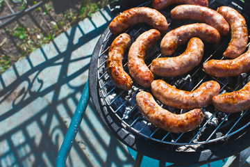 Food. BBQ outside  . Sausages are fried on the grill.