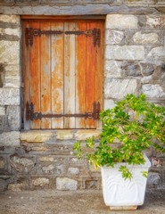 Fototapeta na wymiar Greece, wooden window of traditional stone house