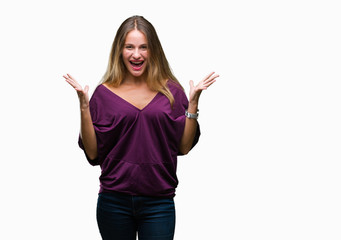 Young beautiful blonde elegant woman over isolated background celebrating crazy and amazed for success with arms raised and open eyes screaming excited. Winner concept