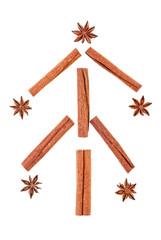 Christmas tree made from anise star seeds and cinnamon sticks on a white background