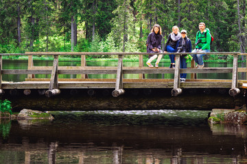 Young friends posing at bridge in Valaam island Karelia