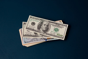 Stack of dollars on a dark background