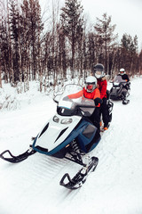 Women and Man on Snowmobile in Winter Finland Lapland Christmas