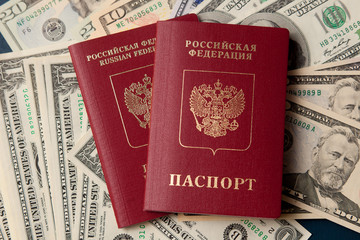 two Russian passports on the background of dollars