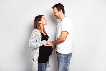 A Pregnant woman with man on studio isolated on white
