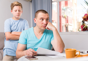 Obraz premium Man is offended and son is not wanting talking with him