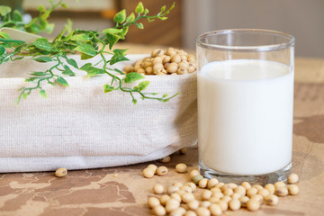 Soy milk in glass and soy bean on bucket. Nature healthy concept.