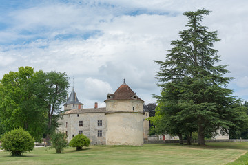 Fototapeta na wymiar The Chateau de La Brede is a feudal castle in the commune of La Brede in the departement of Gironde, France. Summer cloudy day
