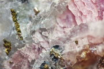 Pink crystals Rhodochrosite with particles of Pyrite. Natural  texture of mineral for background. Beautiful background and wallpaper. Macro.