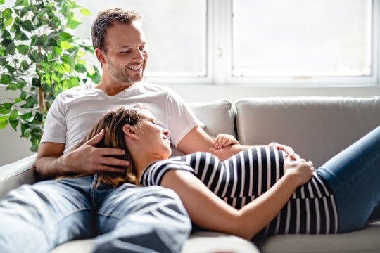 A pregnancy and people concept happy man pregnant woman at home