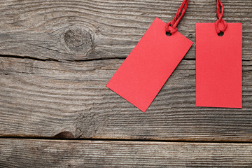 Red sale tags on grey wooden table