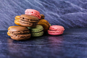 Concept sweets, enjoyment of the senses. Close up of French macaroons on a colorful background....