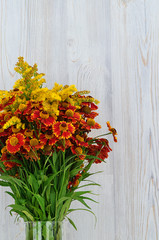 Bouquet of red and yellow flowers. Beautiful combination of colors. Mimosa. Bouquet of wild flowers.