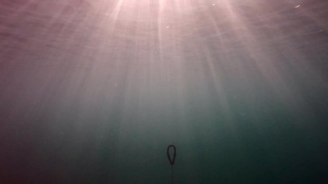 A boat's chain line and trush under sea in Greece