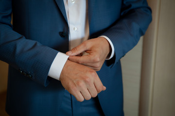 the man corrects cuffs on a sleeve