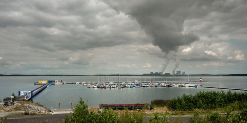 Fototapeta na wymiar Panorama of lake with yachting club and thermal power station in background
