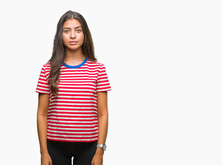 Young beautiful arab woman over isolated background with serious expression on face. Simple and natural looking at the camera.