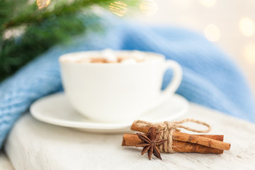 Cup of hot coffee with spices anise and cinnamon. Winter background